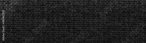 Black brick wall. Texture of old dark brickwork panoramic backgorund.