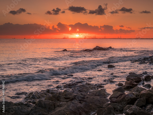Seashore Sunrise with Port on the Horizon