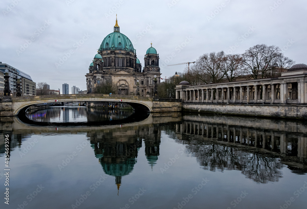 View of the Berliner Dom (Berlin Cathedral), a monumental German Evangelical church and dynastic tomb (House of Hohenzollern) on the Museum Island in central Berlin from the bank of the River Spree
