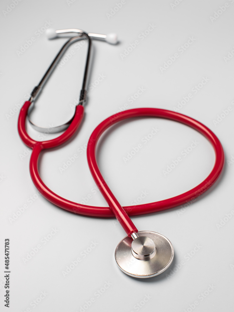 The stethoscope is isolated on a light background. The stethoscope is isolated on a light background.
