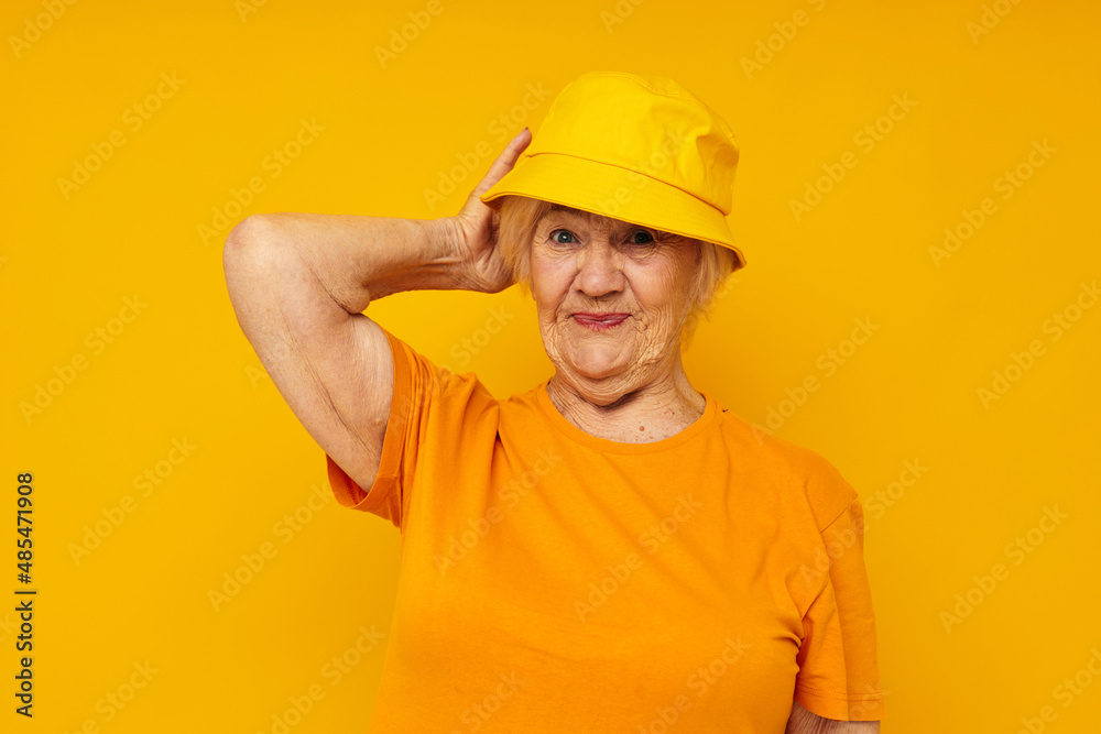 smiling elderly woman happy lifestyle in a yellow headdress yellow background