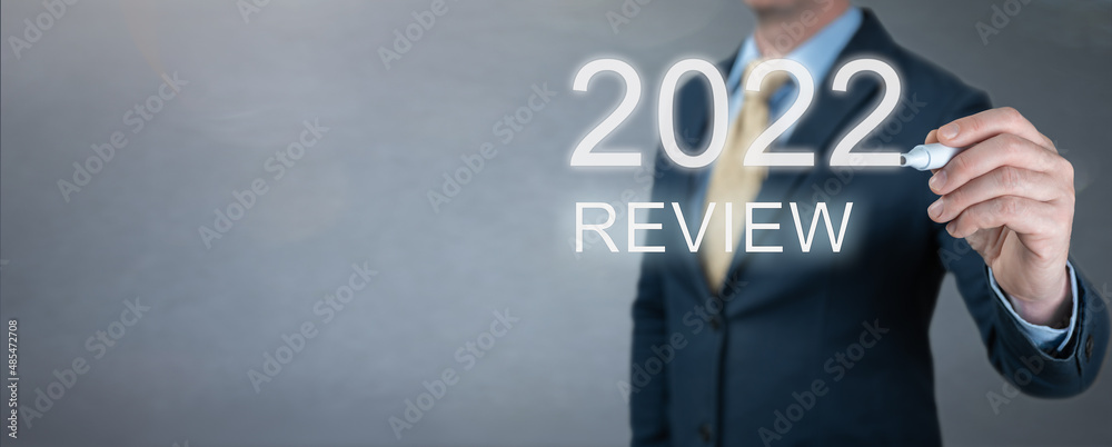 businessman writes 2022 review words. businessman writes 2022 results on virtual screen. economic indicators, overcoming crisis and economic recovery after coronavirus pandemic in 2022 businessman writes 2022 review words. businessman writes 2022 results on virtual screen. economic indicators, overcoming crisis and economic recovery after coronavirus pandemic in 2022