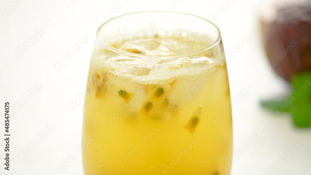 Making delicious passion fruit with sparkling carbonated water on white table background. Making delicious passion fruit with sparkling carbonated water on white table background.
