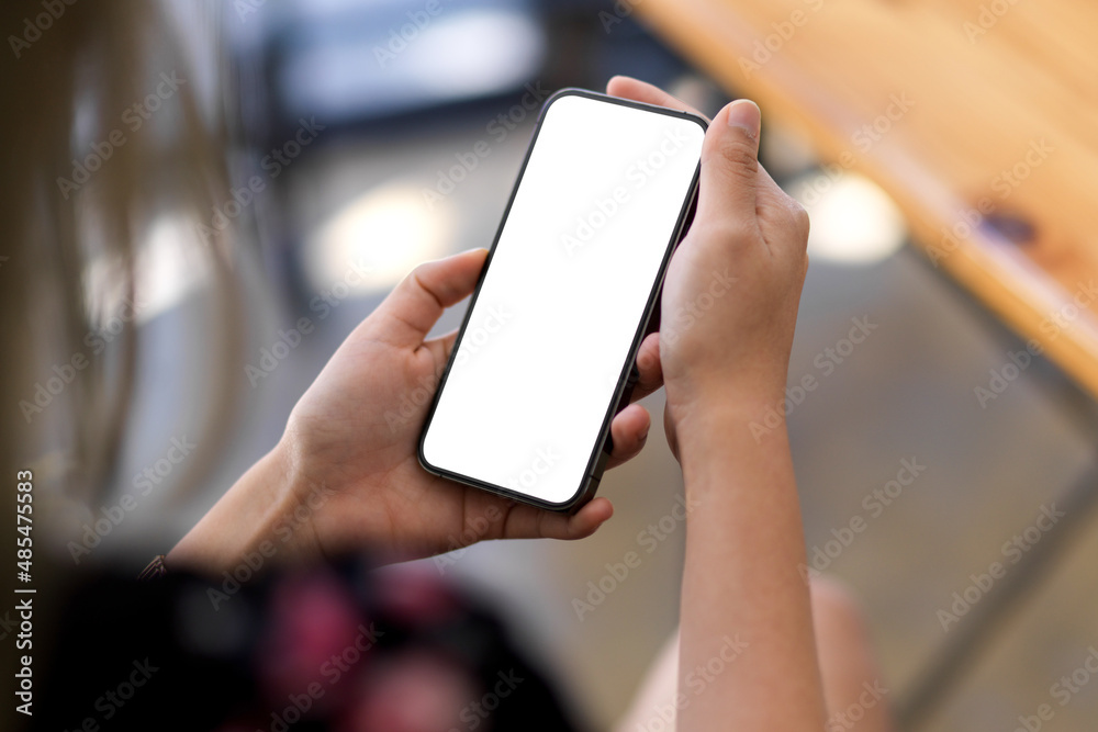 A smartphone blank screen mockup in women's hands template