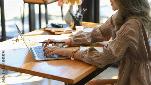 Side view, Elegant female employee working on notebook laptop