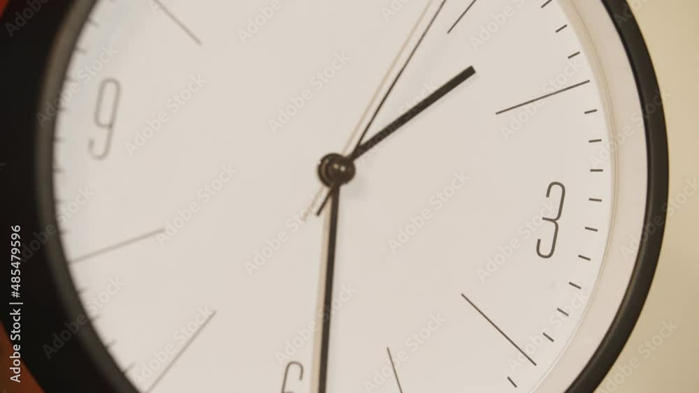 Ticking analog clock in bedroom