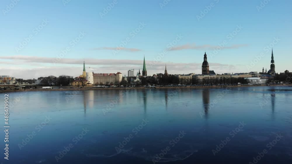 Panorama aerial view towards Riga old town with reflection in frozen Daugava river on a cold winter morning Panorama aerial view towards Riga old town with reflection in frozen Daugava river on a cold winter morning