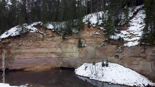 Rising aerial close up of a sand cliff outcrop in winter. Shot in Suur Taevaskoda in Southern Estonia. photo