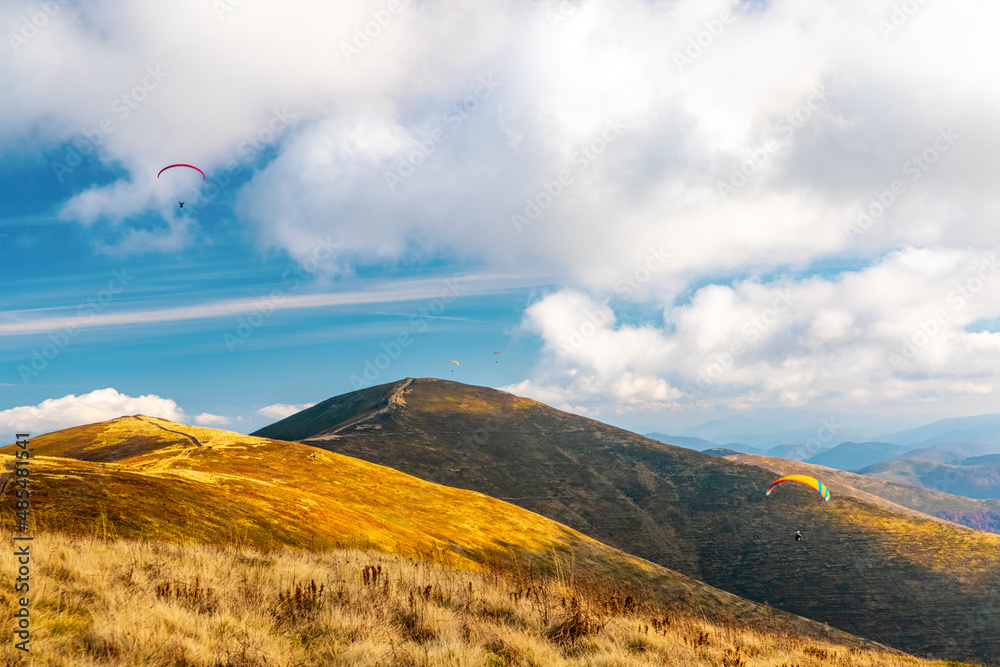 Paragliding active sport against giant mountains in highland