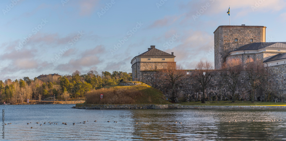 A redoubt building with surrounding cliff blocks in the archipelago town Vaxholm a winter day in Stockholm

