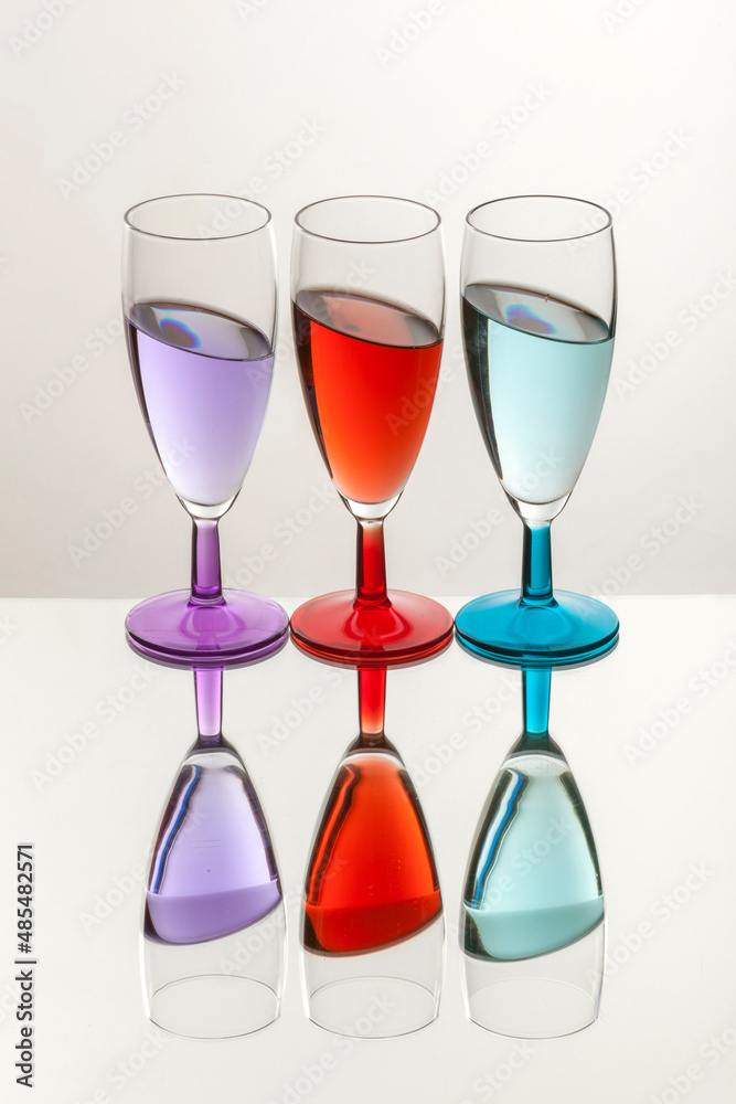 goblets filled with colored liquids white background goblets filled with colored liquids white background