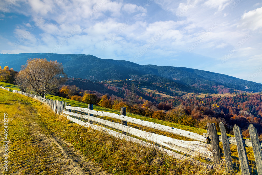 Wooden fence built along ground grassy road in highland Wooden fence built along ground grassy road in highland