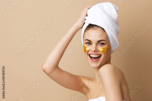 beautiful woman with a towel on his head gesturing with his hands skin care isolated background