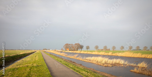 Typical dutch open landscape on a windy day (stormy sky) photo