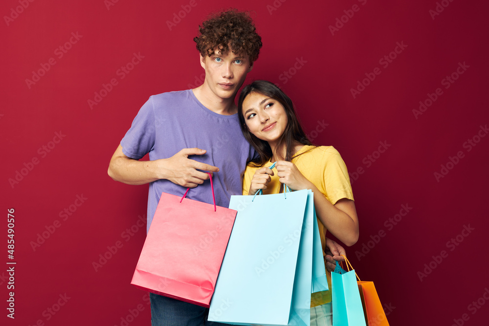 young boy and girl colorful bags shopping fun Lifestyle unaltered