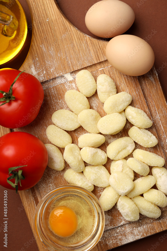 Concept of cooking with raw potato gnocchi, top view Concept of cooking with raw potato gnocchi, top view