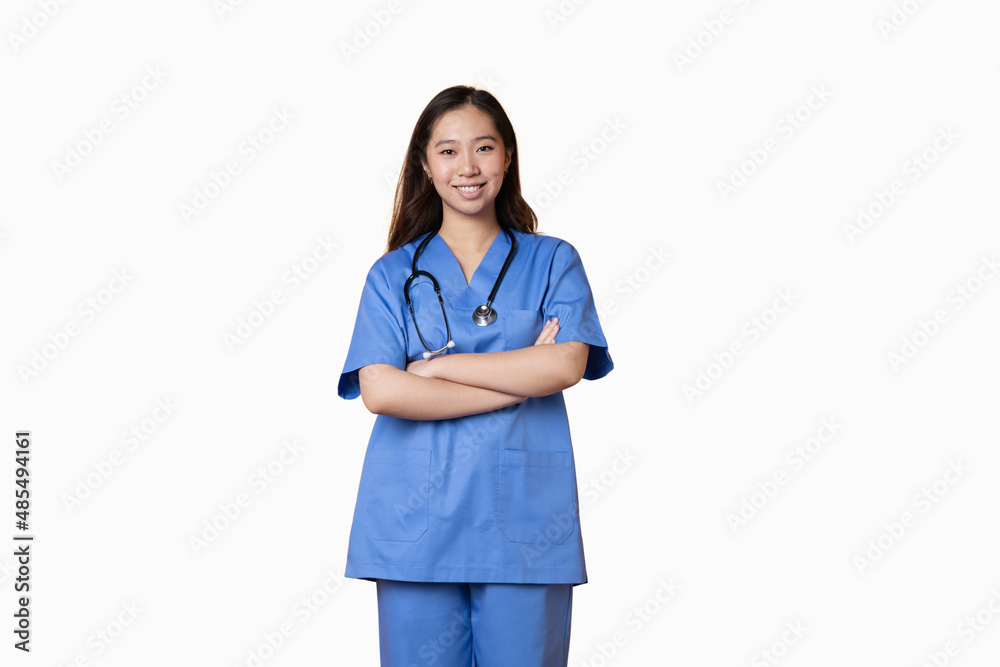 Doctor in a uniform standing with her arms crossed and smiling at the camera Doctor in a uniform standing with her arms crossed and smiling at the camera
