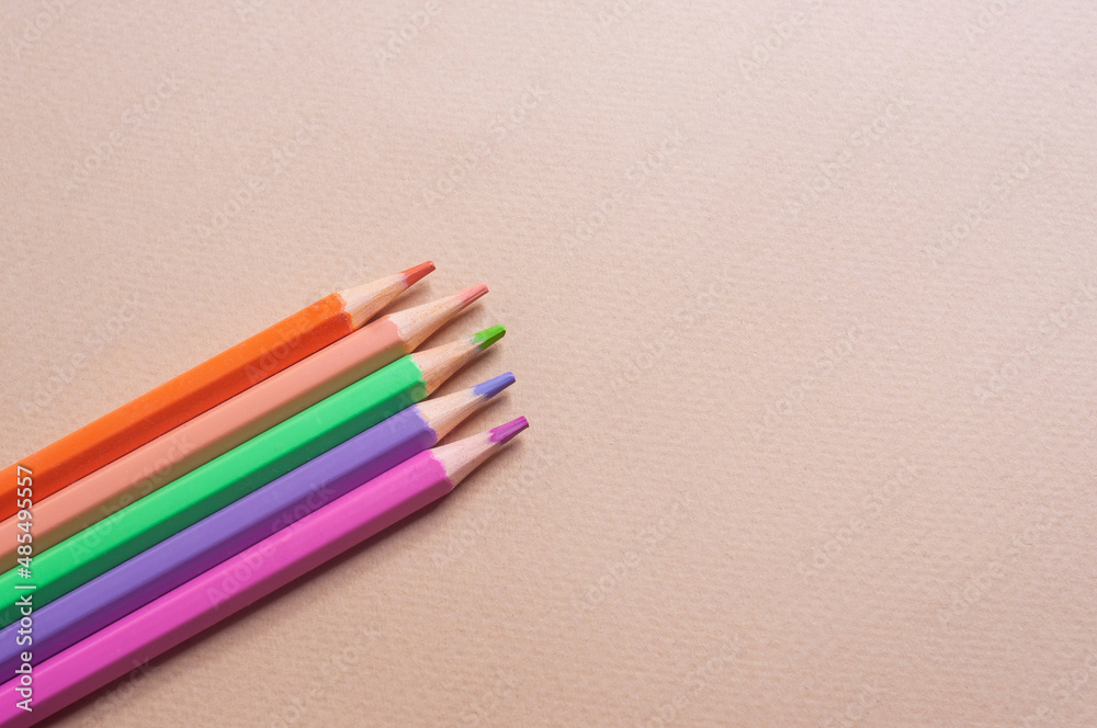 Colorful pencils on light yellow backgroundcreativity concept copy spaccee flat lay Colorful pencils on light yellow backgroundcreativity concept copy spaccee flat lay