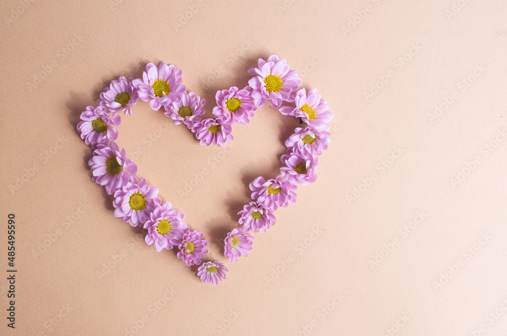Beautiful light purple flower heart on light yellow background copy space valentine's day spring concept