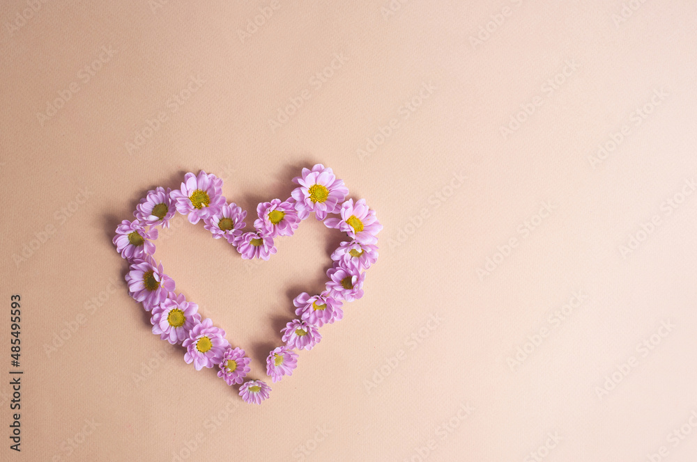 Beautiful light purple flower heart on light yellow background copy space valentine's day spring concept