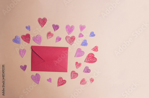 Valentine's day concept crayon hearts and red envelope copy space flat lay photo