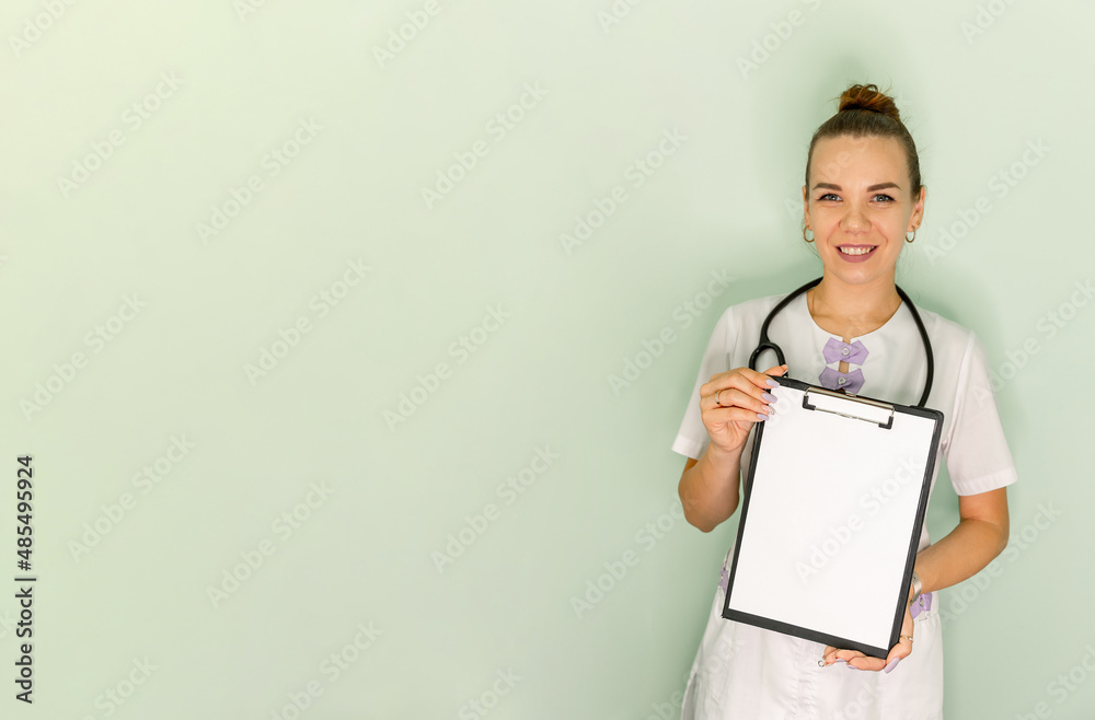 Doctor holding blank white banner. Young female doctor with paper holder. Medical clipboard. Female holding a blank sheet of paper with space for text. A doctor with a sheet paper in his hand Doctor holding blank white banner. Young female doctor with paper holder. Medical clipboard. Female holding a blank sheet of paper with space for text. A doctor with a sheet paper in his hand