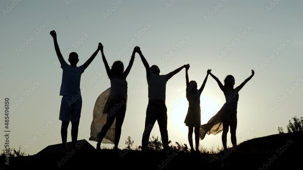 happy family parents holding hands raised their hands up. dad mom daughter and son are dream happy in park. family friendly kid dream concept. happy family parents holding hands raised their hands up. dad mom daughter and son are dream happy in park. family friendly kid dream concept.