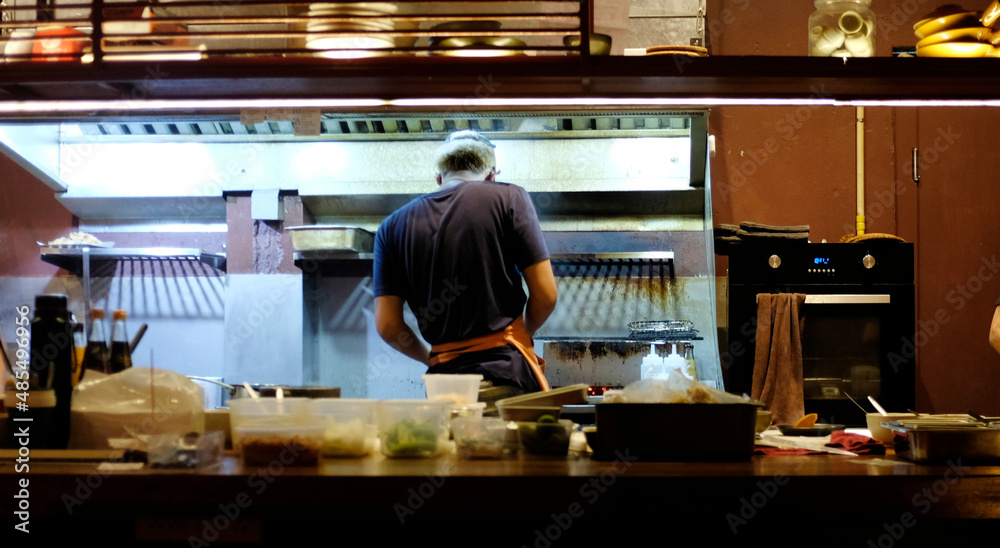  Chefs cooking breakfast in a hotel restaurant kitchen.