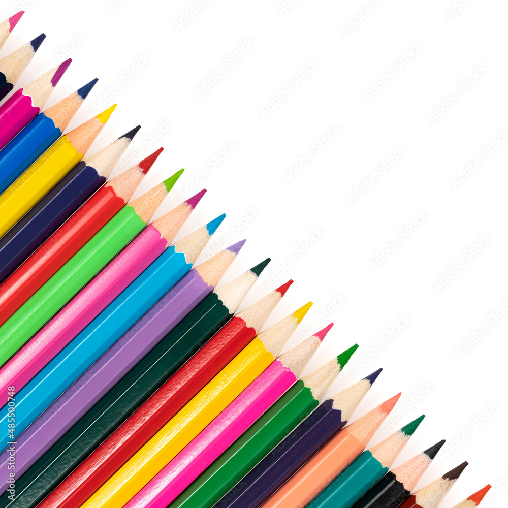 Wooden colored pencils isolated on a white background. A line of multicolored pencils in a large plan Wooden colored pencils isolated on a white background. A line of multicolored pencils in a large plan