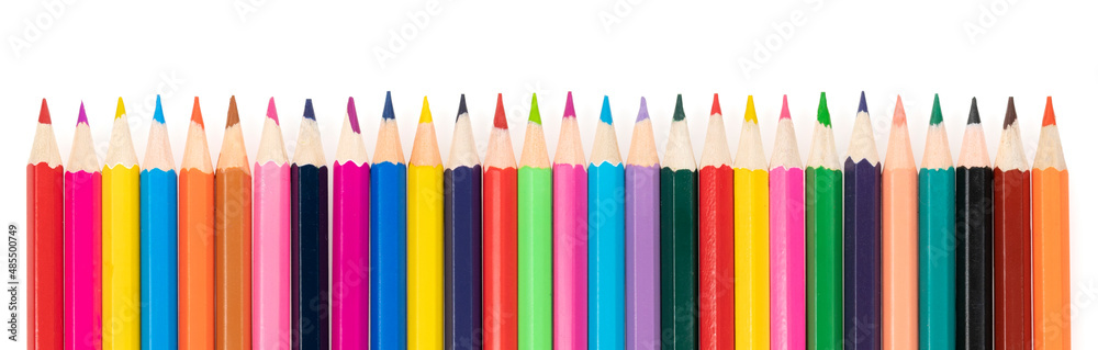 Wooden colored pencils isolated on a white background. A line of multicolored pencils in a large plan Wooden colored pencils isolated on a white background. A line of multicolored pencils in a large plan