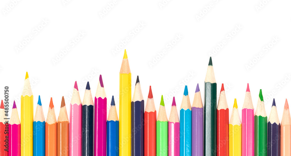 Wooden colored pencils isolated on a white background. A line of multicolored pencils in a large plan Wooden colored pencils isolated on a white background. A line of multicolored pencils in a large plan