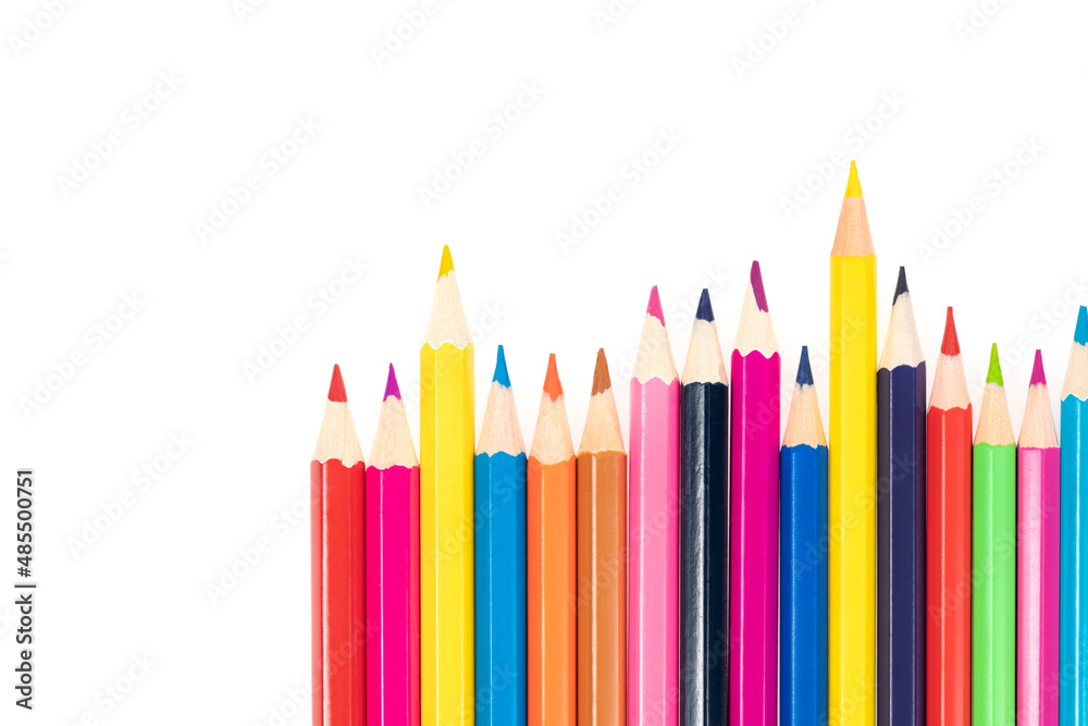Wooden colored pencils isolated on a white background. A line of multicolored pencils in a large plan Wooden colored pencils isolated on a white background. A line of multicolored pencils in a large plan