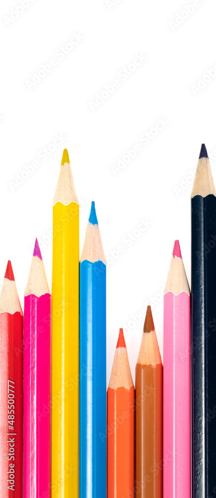 Wooden colored pencils isolated on a white background. A line of multicolored pencils in a large plan Wooden colored pencils isolated on a white background. A line of multicolored pencils in a large plan