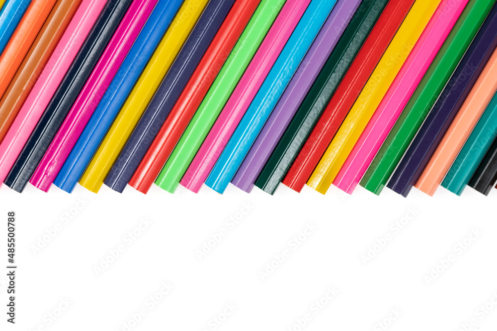 Wooden colored pencils isolated on a white background. A line of multicolored pencils in a large plan Wooden colored pencils isolated on a white background. A line of multicolored pencils in a large plan