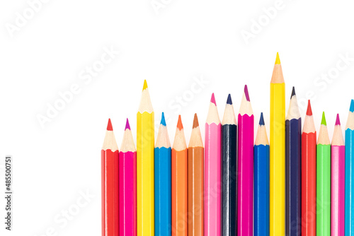 Wooden colored pencils isolated on a white background. A line of multicolored pencils in a large plan