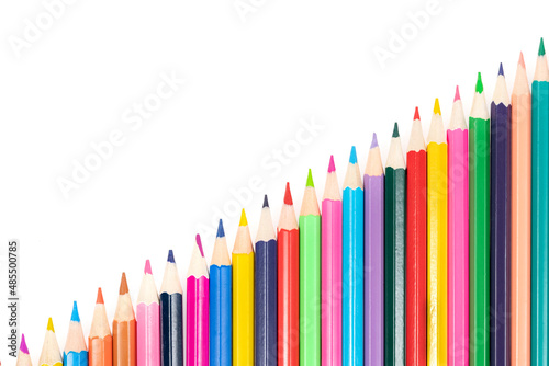 Wooden colored pencils isolated on a white background. A line of multicolored pencils in a large plan