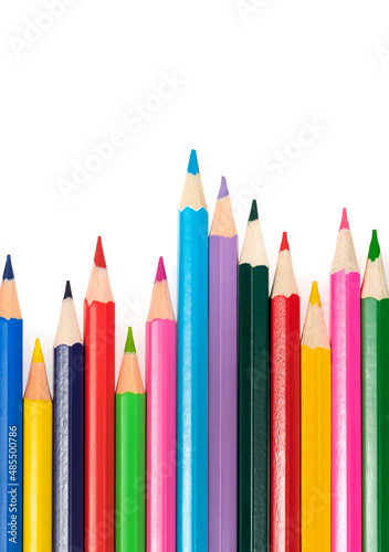 Wooden colored pencils isolated on a white background. A line of multicolored pencils in a large plan