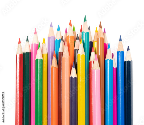 Wooden colored pencils isolated on a white background. A line of multicolored pencils in a large plan