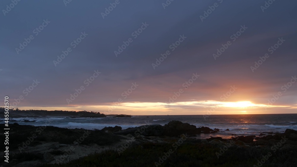 Rocky craggy pacific ocean coast, sea water waves crashing on rocks, 17-mile drive, Monterey California USA. Dramatic sunset sky nature near Point Lobos, Big Sur, Pebble beach. Rainy cloudy weather. Rocky craggy pacific ocean coast, sea water waves crashing on rocks, 17-mile drive, Monterey California USA. Dramatic sunset sky nature near Point Lobos, Big Sur, Pebble beach. Rainy cloudy weather.