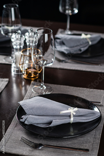 beautifully laid tables with glasses and appliances in restaurant