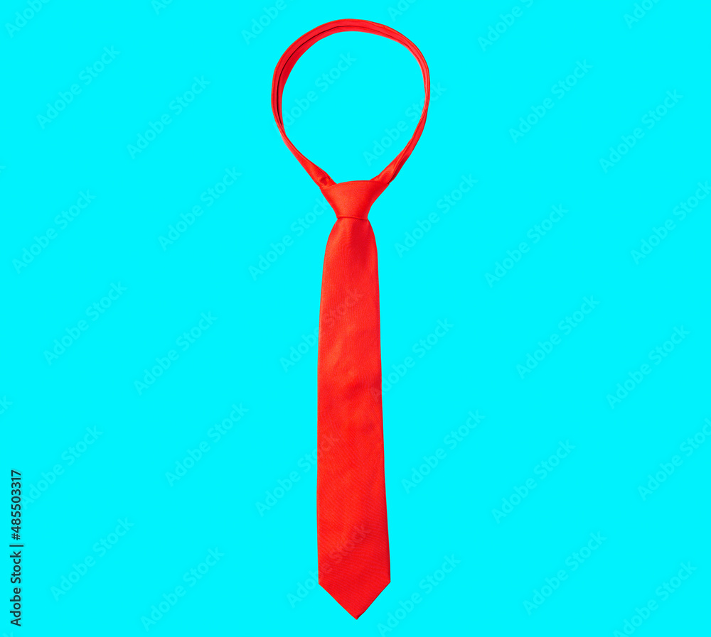 Solid red tie isolated on blue background Solid red tie isolated on blue background