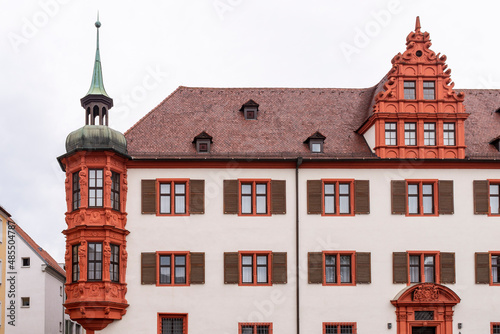 Sightseeing in Bavaria, Germany. Vibrant red architectural details of Bischöfliches Palais (Bishop's Palace) on cloudy day in summer. 