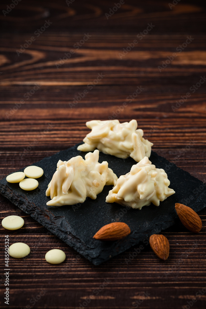 Fototapeta premium Heap of sugared almonds nut candies in white chocolate