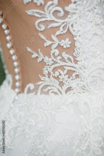 close-up of a wedding dress and pattern. shoulder and back, rear view