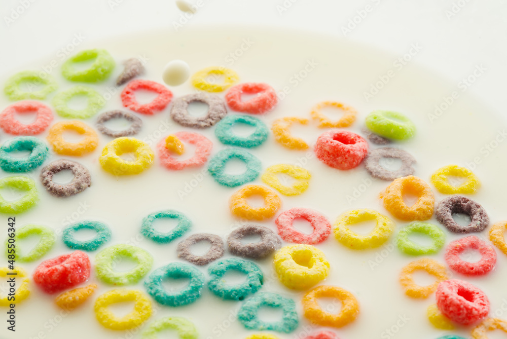 Fruit colored cereal snacks on a white background. Quick breakfasts. Abstraction. School and children's food. Healthy lifestyle. Lots of objects. Soft focus. Fruit colored cereal snacks on a white background. Quick breakfasts. Abstraction. School and children's food. Healthy lifestyle. Lots of objects. Soft focus.
