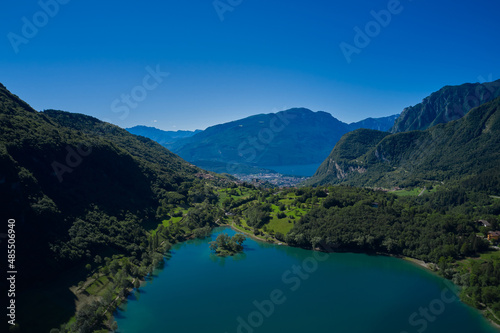 Aerial view of Lake Tenno in autumn  Trento  Italy  Europa. Turquoise lake in the mountains. Lake Garda in the background.  Mountain lake in the alps of Italy.