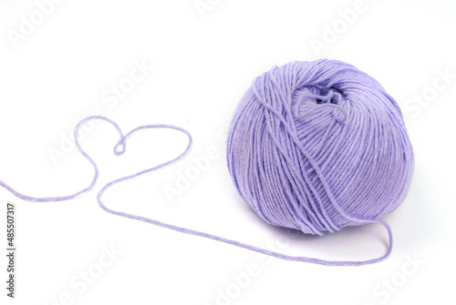 Woolen yarn isolated on white background in the form of a violet heart valentine's day