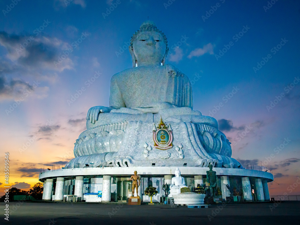 Fototapeta premium Big Buddha statue Was built on high hilltop of Phuket Thailand. Can be seen from distance, Big Buddha is one of Phuket island most important and revered landmarks against the sunset sky. Bottom view