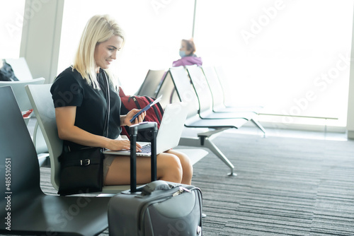 young woman using laptop computer at airport