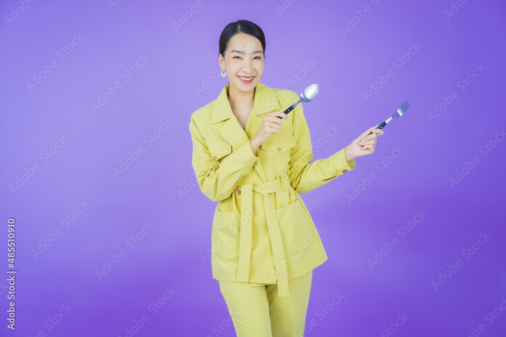 Portrait beautiful young asian woman smile with spoon and fork Portrait beautiful young asian woman smile with spoon and fork